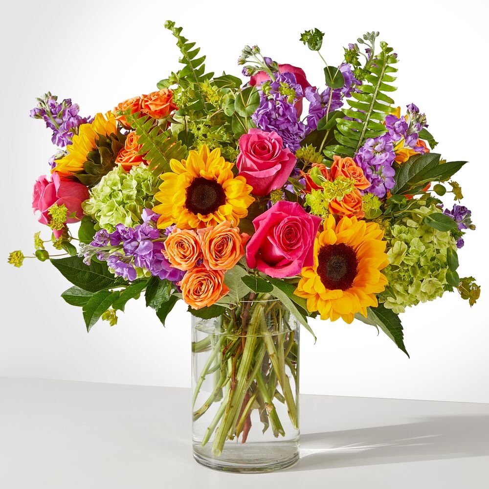  vibrant bouquet with sunflowers, hot pink roses, green hydrangeas, and purple blooms, same-day delivery in Miami.